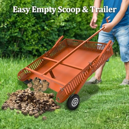 Orange scoop and trailer on grass with manure.