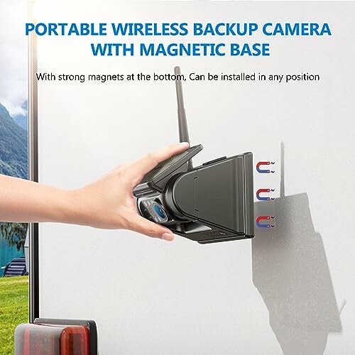 Hand installing portable wireless backup camera with magnetic base on vehicle.